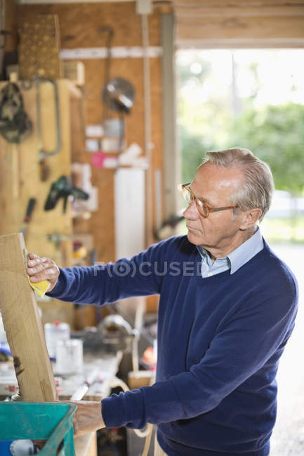 Hombre trabajando en garaje - foto de stock