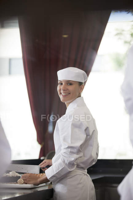 Chef chopping in restaurant kitchen — Stock Photo