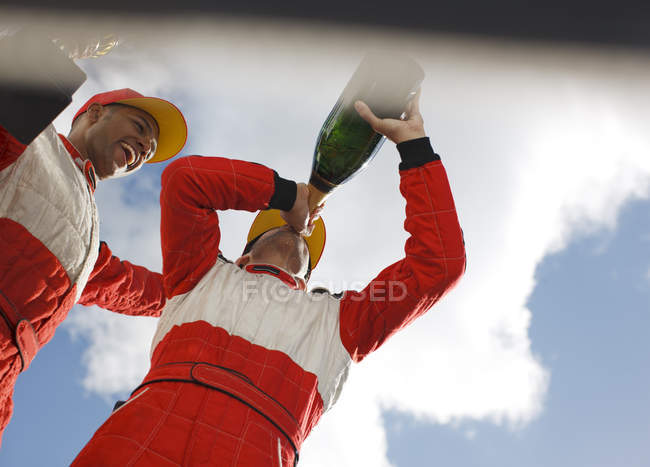 Rennfahrer trinkt Champagner auf der Strecke — Stockfoto