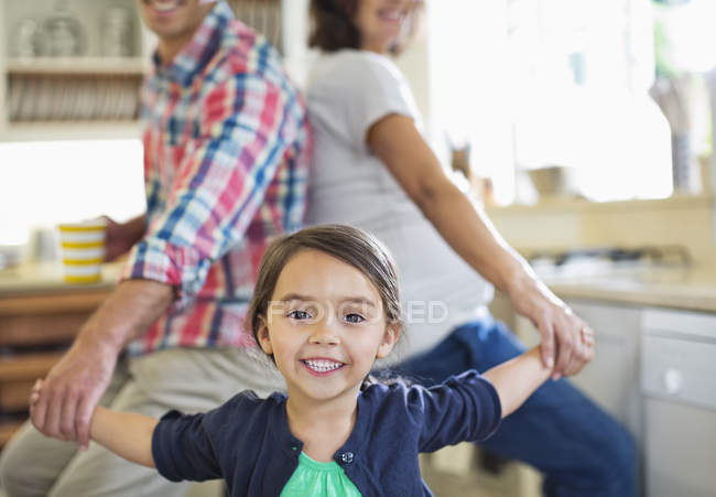 Family holding hands in kitchen — Stock Photo