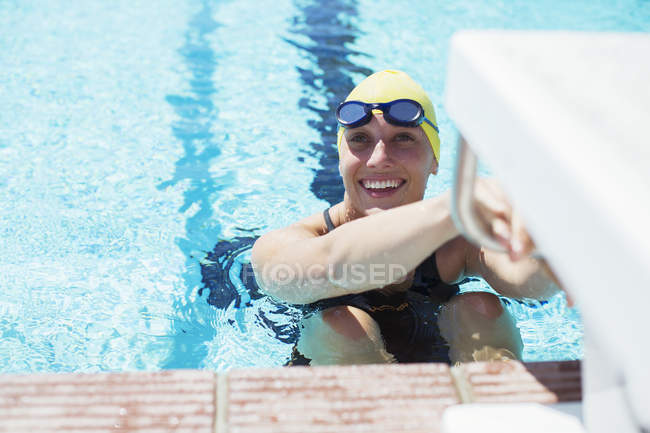 Swimmer poised to start in swimming pool — Stock Photo