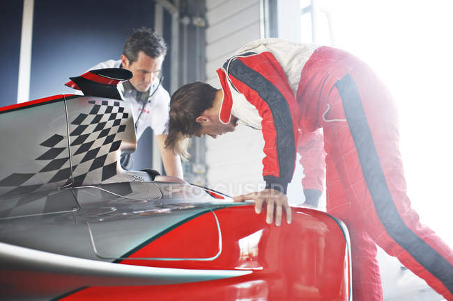 Racing team working on car — Stock Photo