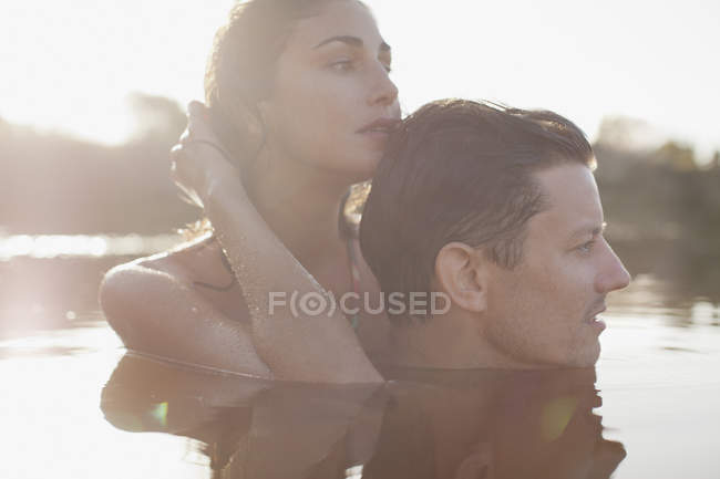 Close up of serene couple swimming in lake — Stock Photo