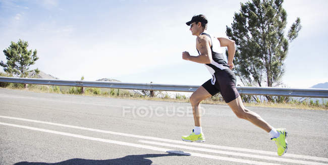 Runner in race on rural road — Stock Photo