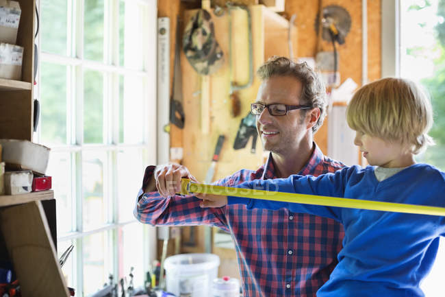 Father and son working in garage — Stock Photo