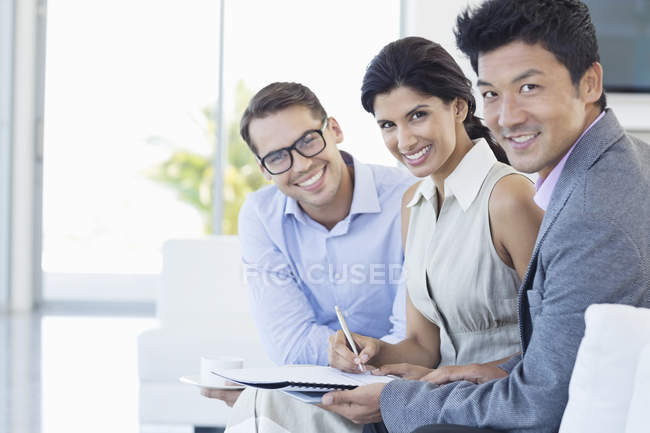 Geschäftsleute lächeln über modernes Büro — Stockfoto