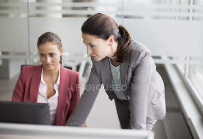 Деловые женщины, работающие вместе за столом в современном офисе — стоковое фото