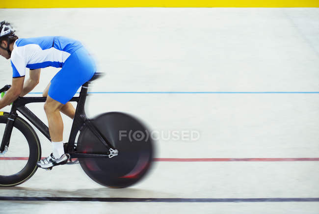 Track cyclist riding in velodrome — Stock Photo