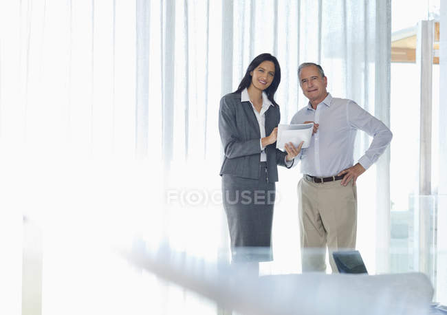 Gente de negocios sonriendo en la oficina - foto de stock