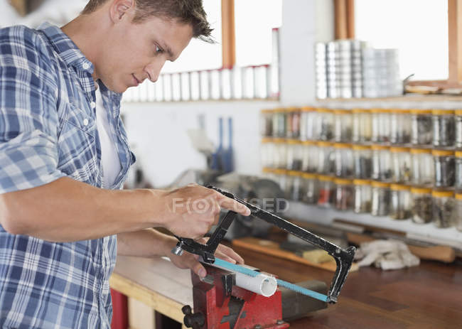 Skillful caucasian man working in workshop — Stock Photo