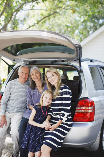 Family sitting in trunk of car — Stock Photo