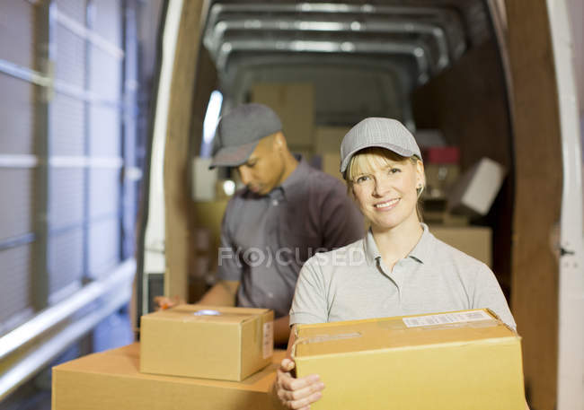 Consegna persone caricamento scatole nel furgone — Foto stock