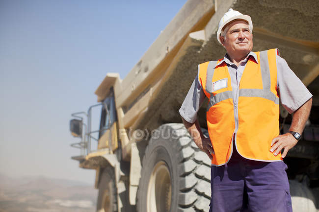 Arbeiter steht an Maschinen auf der Baustelle — Stockfoto