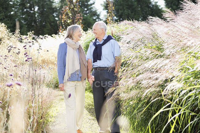 Older couple walking outdoors — Stock Photo