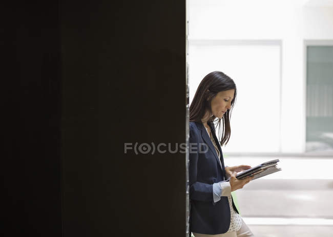 Businesswoman reading in office at modern office — Stock Photo