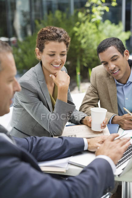 Business people talking in meeting outdoors at modern office — Stock Photo