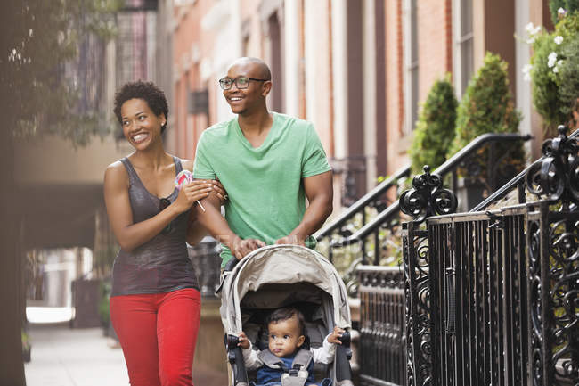 Family walking together on city street — Stock Photo