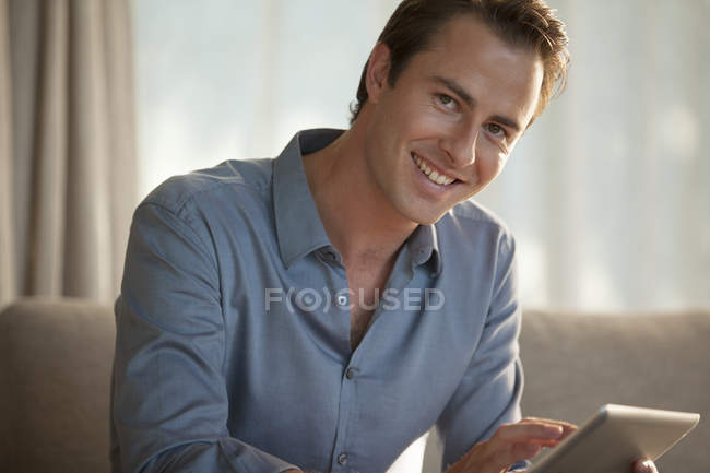 Businessman smiling on sofa — Stock Photo
