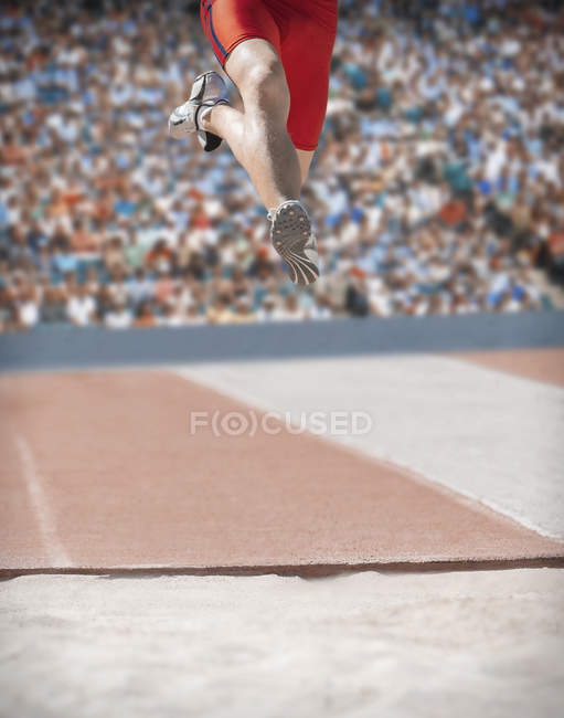 Long jumper over sand pit — Stock Photo