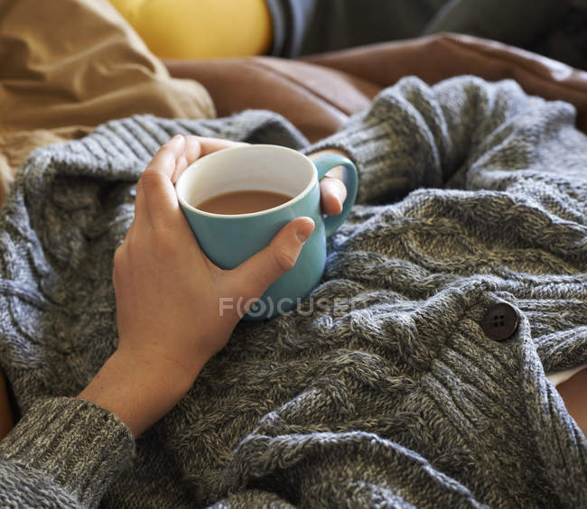 Close up of boy holding cup of tea — Stock Photo