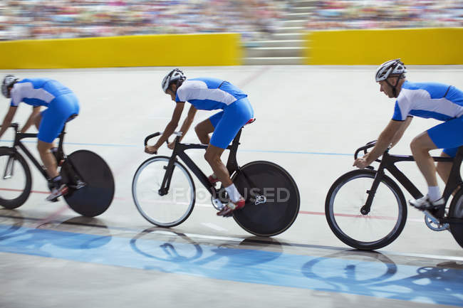 Track cycling team riding in velodrome — Stock Photo