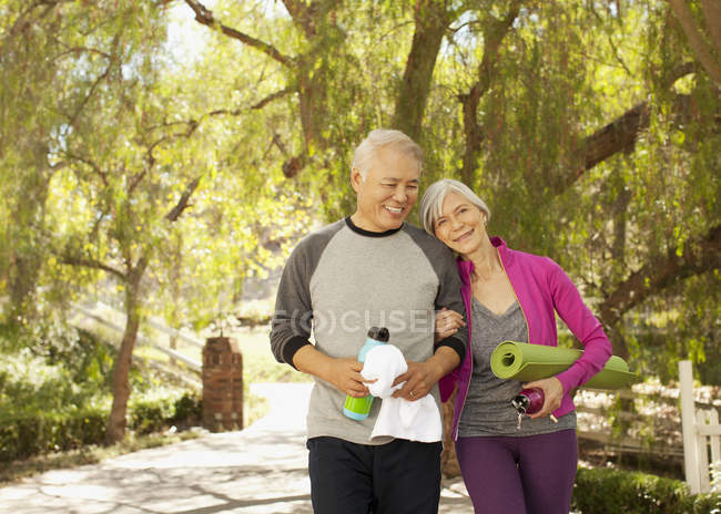 Older couple walking together outdoors — Stock Photo