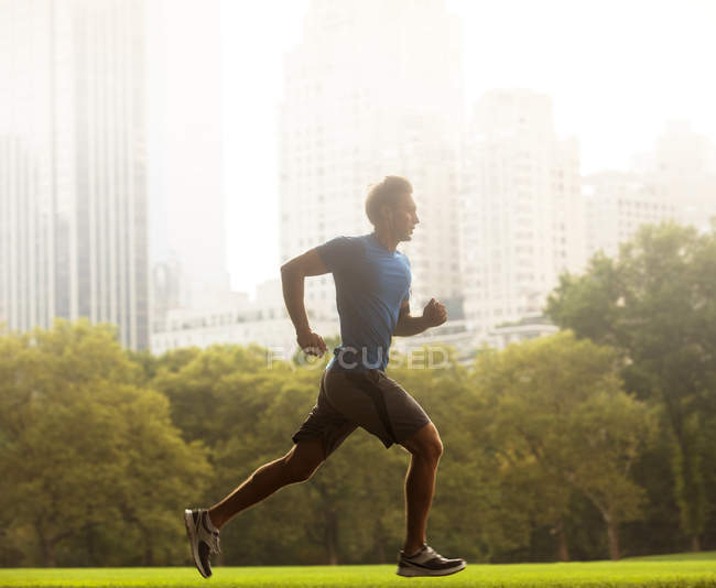 Man running in urban park — Stock Photo