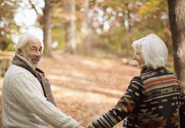 Older caucasian couple walking in park — Stock Photo