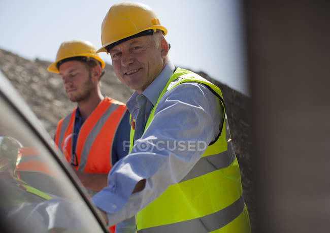 Businessman smiling to camera in quarry — Stock Photo