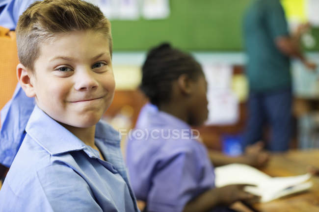 Caucásico macho estudiante sonriendo en clase - foto de stock