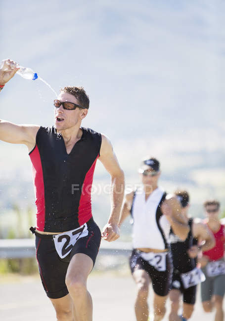 Runners in race on rural road — Stock Photo