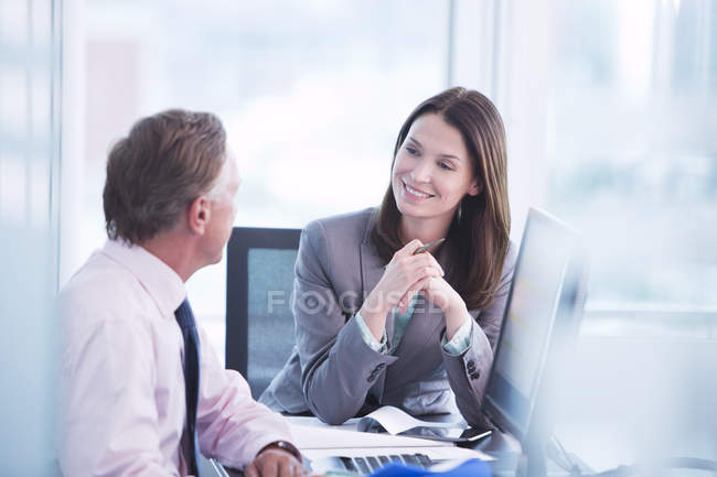 Business people talking at desk at modern office — Stock Photo