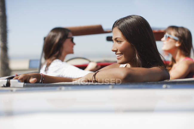 Smiling woman sitting in convertible — Stock Photo