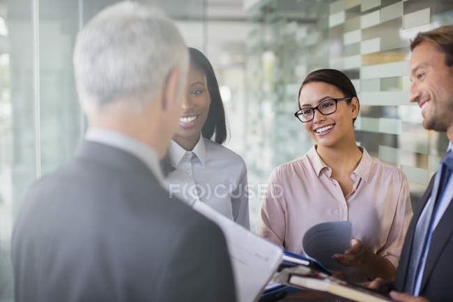 Business people talking in modern office building — Stock Photo