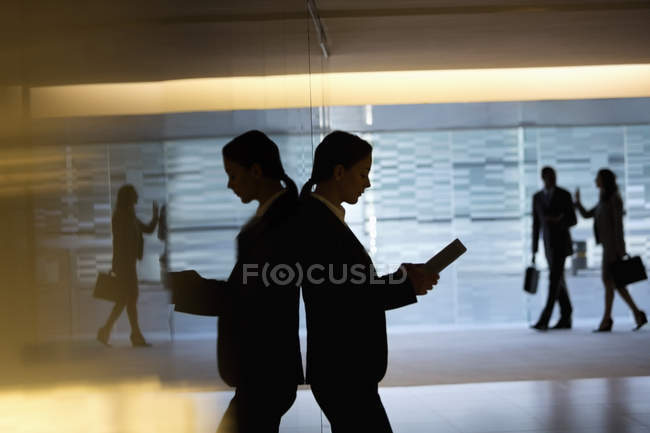Businesswoman using digital tablet in lobby at modern office — Stock Photo