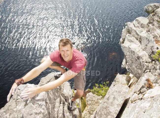 High angle of climber scaling coastal cliff — Stock Photo
