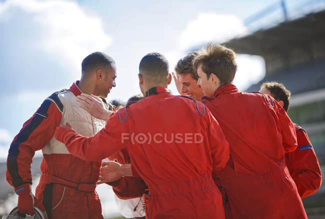 Racer and team talking on track — Stock Photo