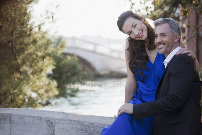 Retrato de una pareja sonriente y bien vestida en el paseo marítimo - foto de stock