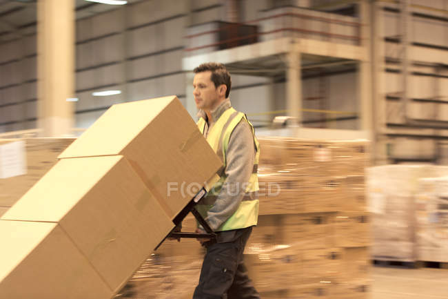 Boîtes de transport de travailleurs dans l'entrepôt — Photo de stock