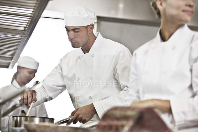 Chefs cooking in restaurant kitchen — Stock Photo