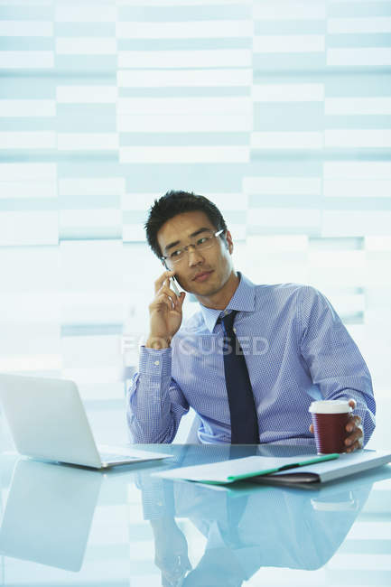 Businessman using laptop in office building cafe — Stock Photo