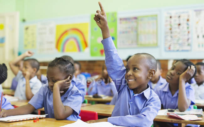 African american student raising hand in class — Stock Photo