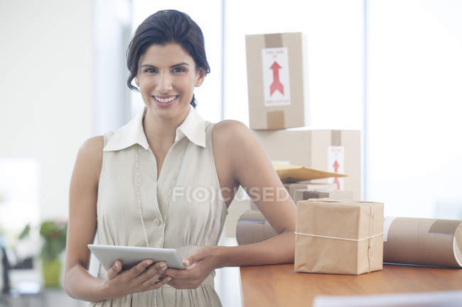 Businesswoman using tablet computer at modern office — Stock Photo