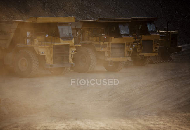 Trucks parked on road in quarry — Stock Photo