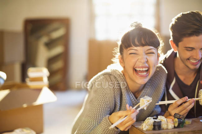 Young couple eating sushi together — Stock Photo