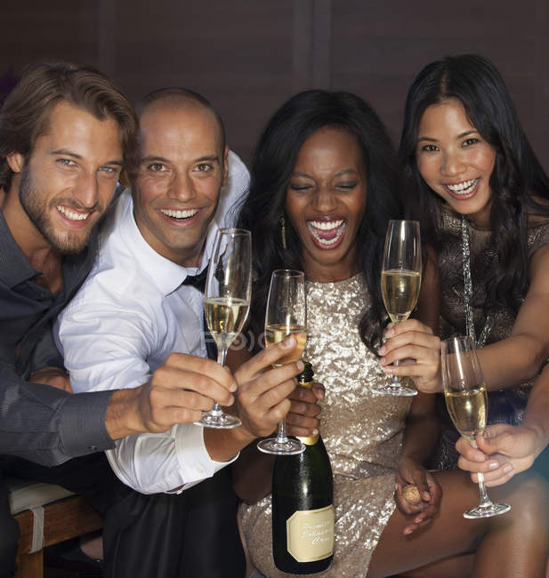 Young attractive Friends toasting each other at party — Stock Photo