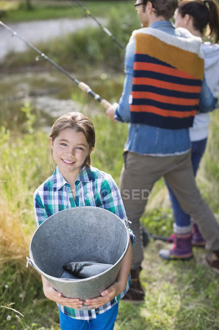 Girl showing off fishing catch — Stock Photo