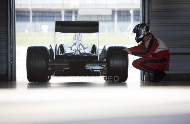 Racer trabalhando no carro na garagem — Fotografia de Stock
