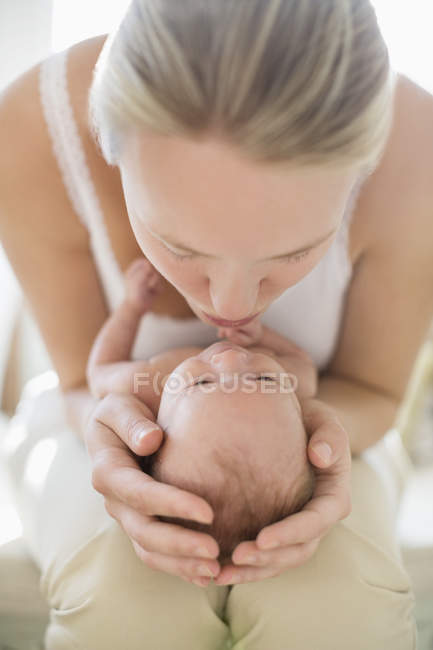 Mother kissing newborn baby — Stock Photo