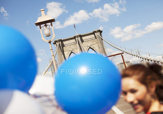 Couple with balloon walking on urban bridge — Stock Photo